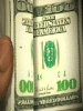 Moving-picture-flipping-through-hundred-dollar-bills-gif-animation.gif